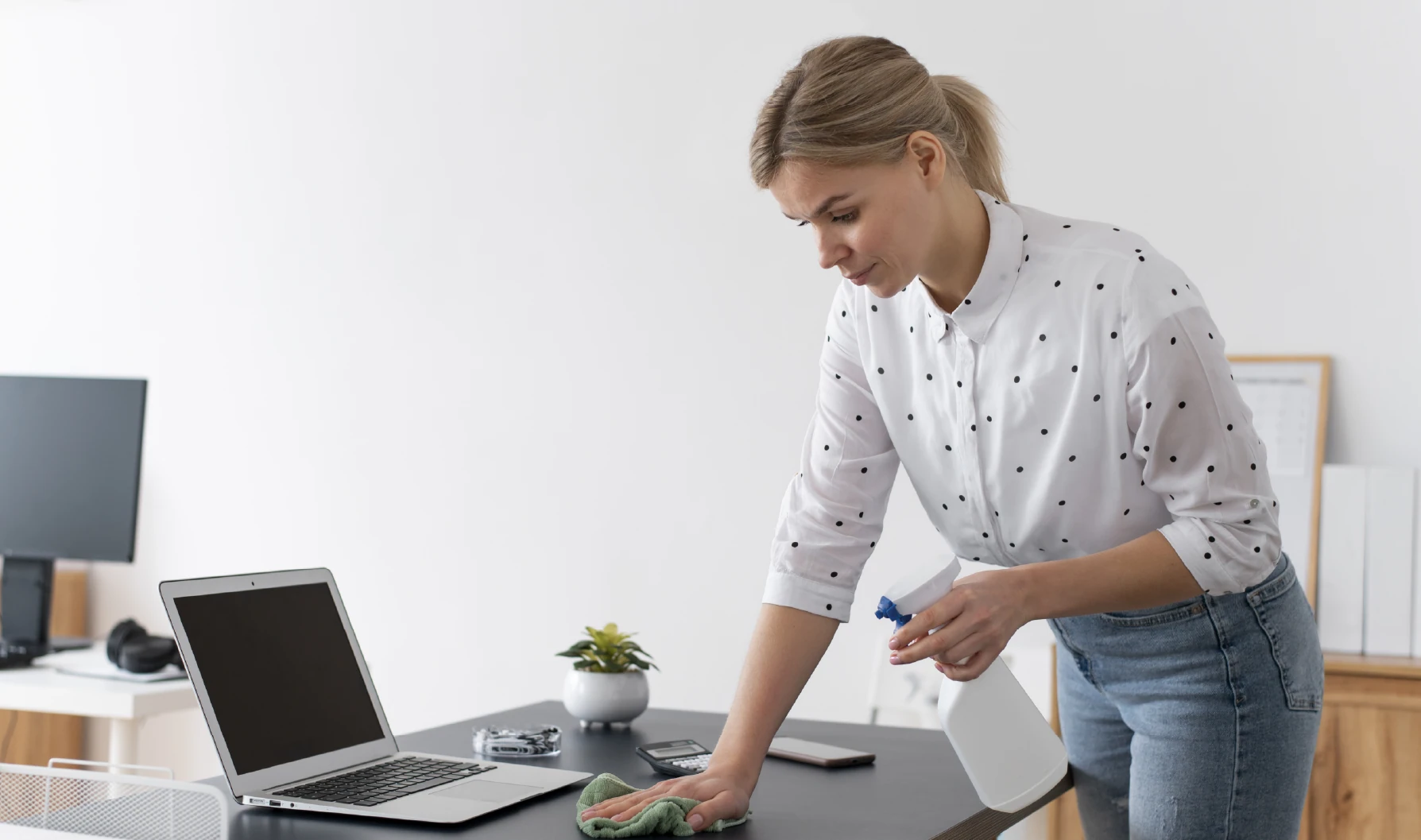 Woman cleaning office desk