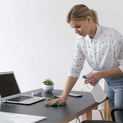 Woman cleaning office desk