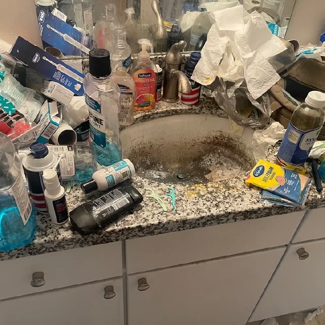 Cluttered messy bathroom sink