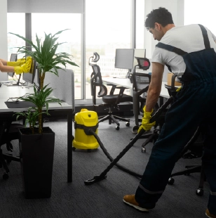 Expert vacuuming office floor